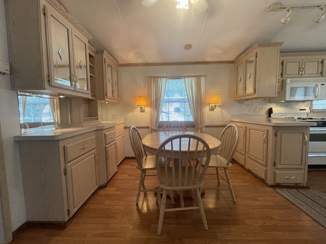 4-52 Woodhaven Lakes Sublette, IL 61367 - Photo 10 of 35 a kitchen with stainless steel appliances granite countertop a table chairs sink and cabinets