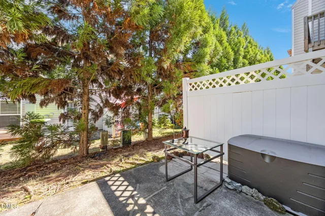 a backyard of a house with table and chairs