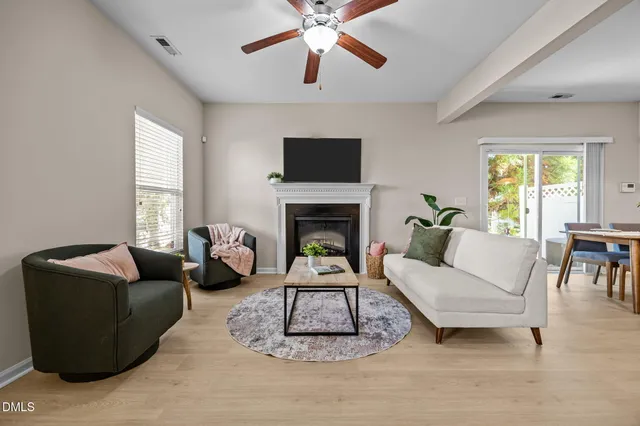 a living room with furniture a fireplace and a flat screen tv