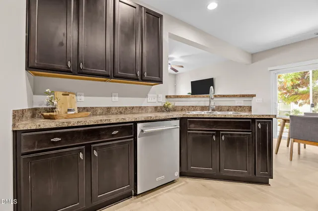 a kitchen with granite countertop cabinets stainless steel appliances and a counter space