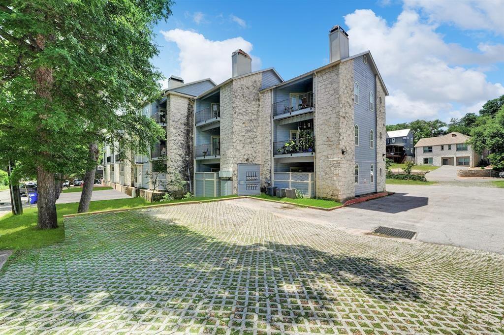 3111 Tom Green Street, Unit 108 Austin, TX 78705 - Photo 12 of 12 a front view of a house with a yard and garage