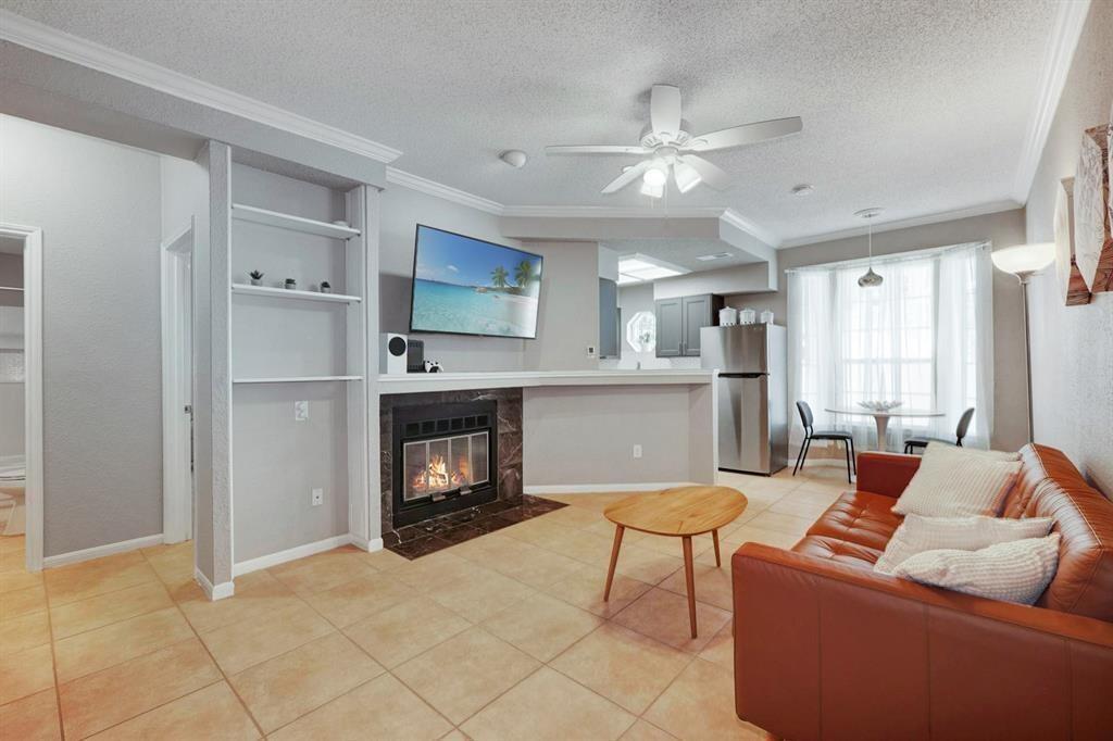 3111 Tom Green Street, Unit 108 Austin, TX 78705 - Photo 2 of 12 a living room with furniture and a fireplace