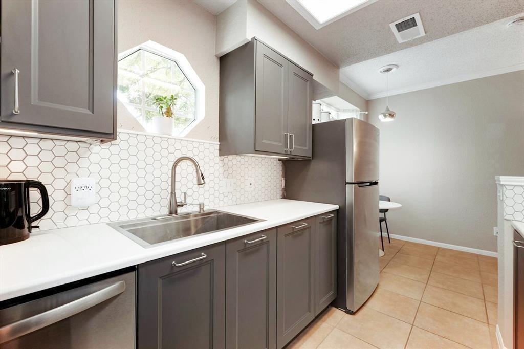 3111 Tom Green Street, Unit 108 Austin, TX 78705 - Photo 3 of 12 a kitchen with a sink and a refrigerator