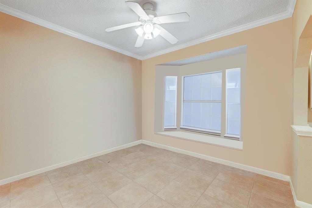 3111 Tom Green Street, Unit 108 Austin, TX 78705 - Photo 5 of 12 an empty room with a chandelier fan and windows
