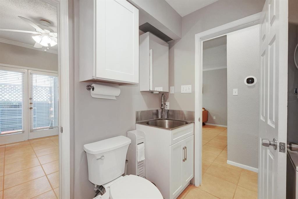 3111 Tom Green Street, Unit 108 Austin, TX 78705 - Photo 8 of 12 a bathroom with a toilet sink and mirror