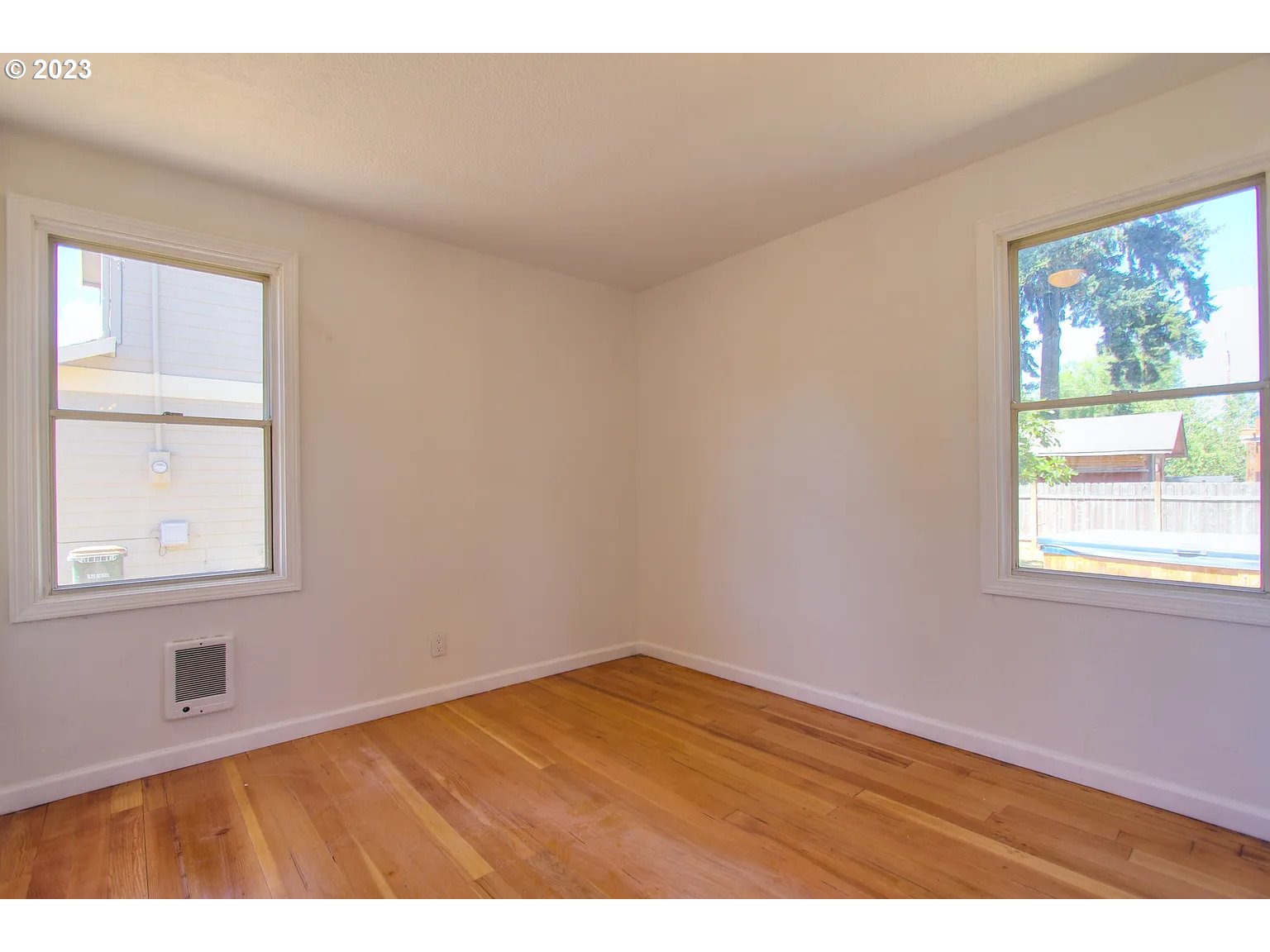 711 Southeast 5th Street Gresham, OR 97080 - Photo 11 of 25 an empty room with wooden floor and windows