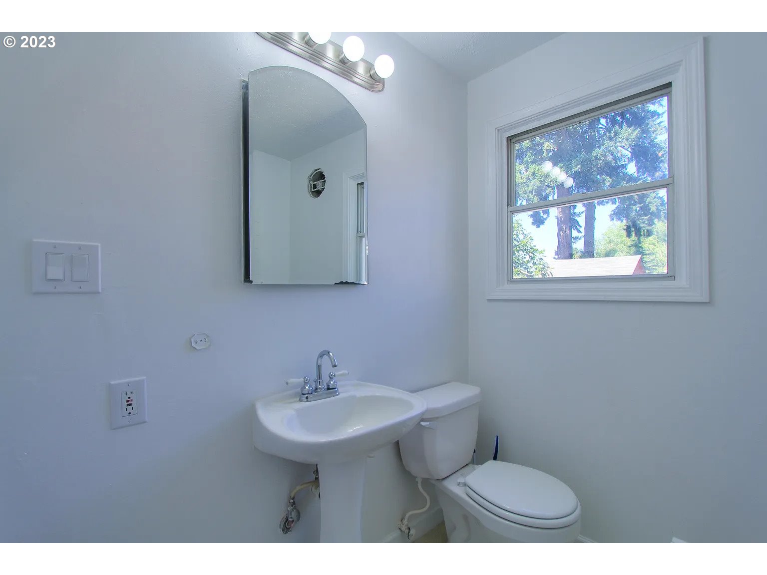 711 Southeast 5th Street Gresham, OR 97080 - Photo 12 of 25 a bathroom with a sink a mirror and a toilet