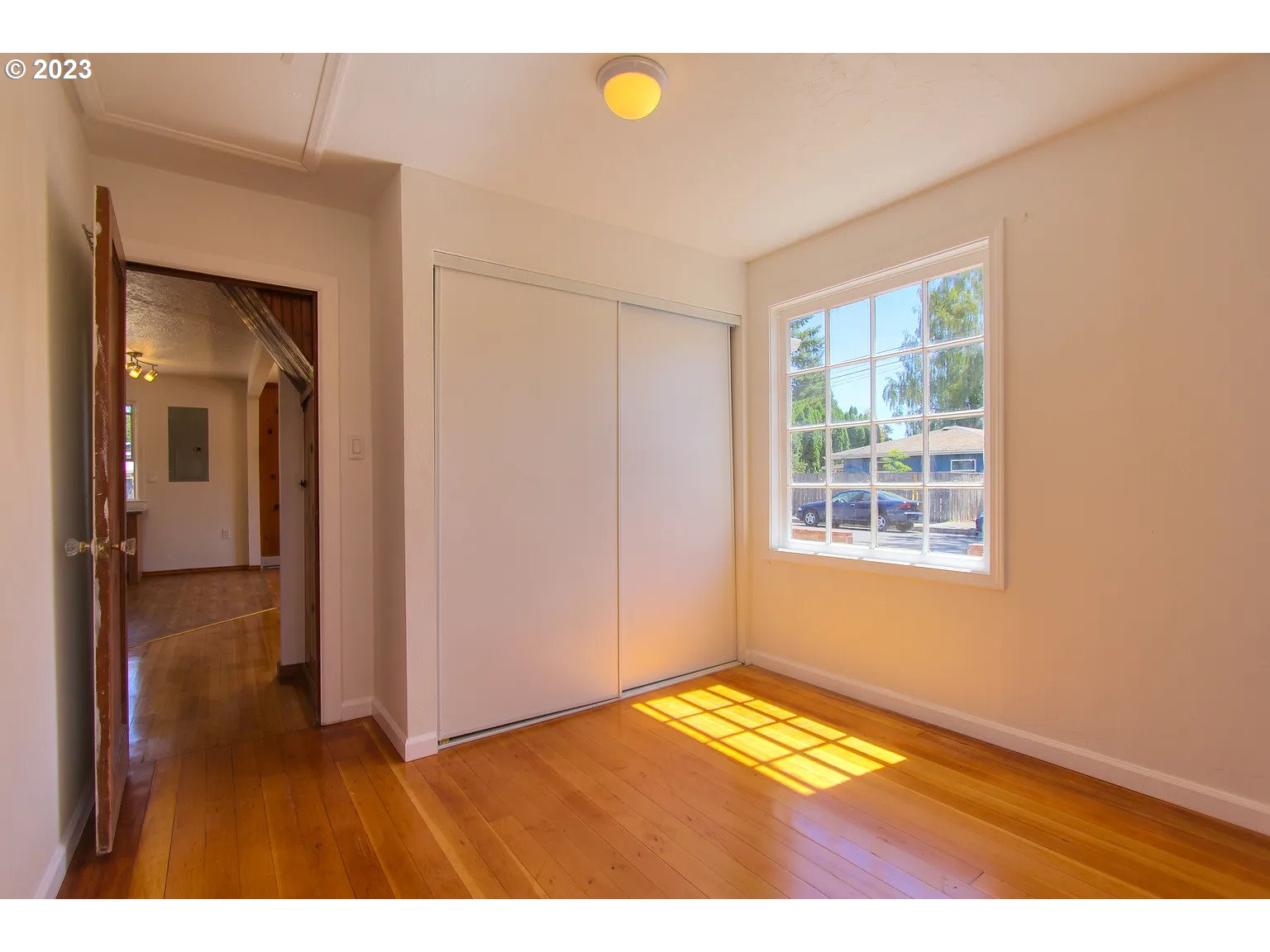 711 Southeast 5th Street Gresham, OR 97080 - Photo 8 of 25 a view of empty room with window and wooden floor