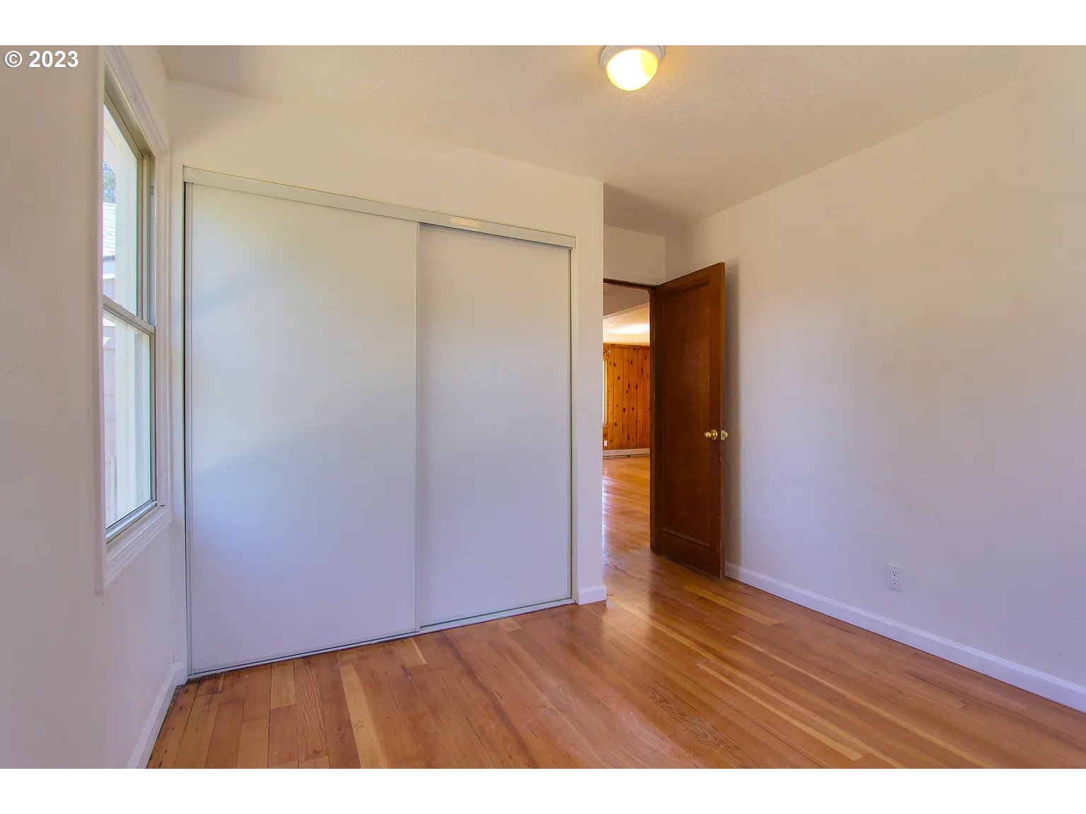 711 Southeast 5th Street Gresham, OR 97080 - Photo 9 of 25 a view of an empty room with wooden floor