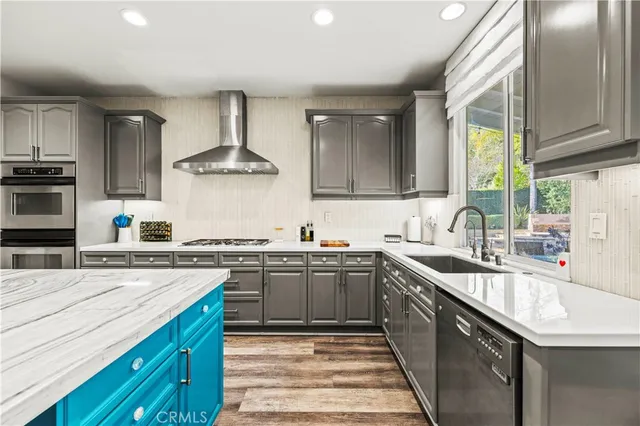 a kitchen with stainless steel appliances granite countertop sink stove and wooden cabinets