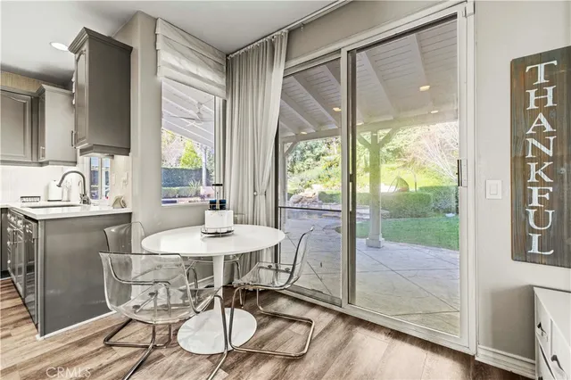 a spacious bathroom with a granite countertop sink a toilet a mirror and shower