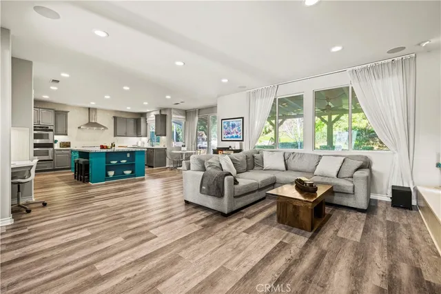 a living room with furniture a fireplace and a large window