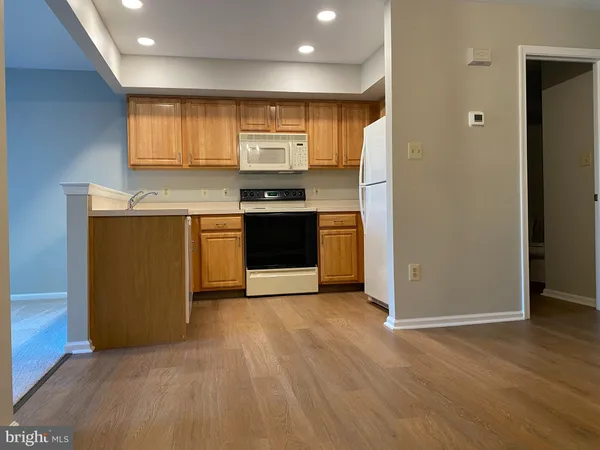 a kitchen with stainless steel appliances granite countertop a refrigerator a sink and a stove