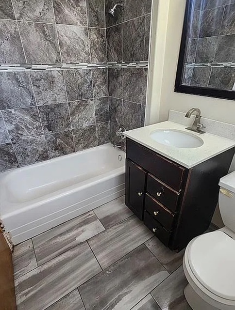 37 Choate Road Park Forest, IL 60466 - Photo 11 of 17 a bathroom with a sink vanity mirror bathtub and toilet