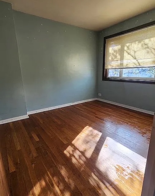 37 Choate Road Park Forest, IL 60466 - Photo 13 of 17 an empty room with wooden floor and windows
