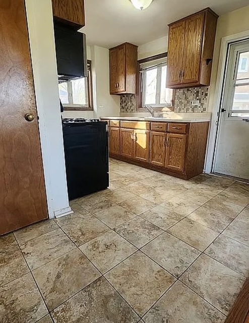 37 Choate Road Park Forest, IL 60466 - Photo 8 of 17 a kitchen with stainless steel appliances granite countertop a stove a sink and a refrigerator