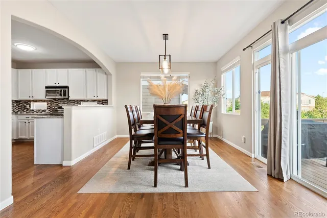 a view of a dining room with furniture window and wooden floor