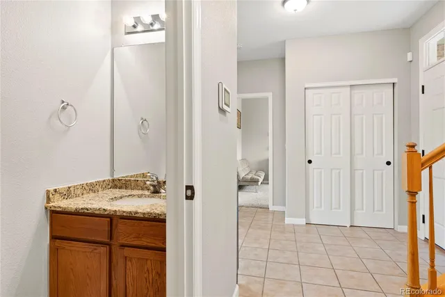 a bathroom with a granite countertop sink and a mirror
