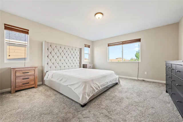 a spacious bedroom with a bed and a window