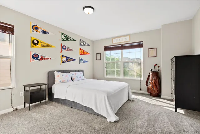 a bedroom with a bed and a large window