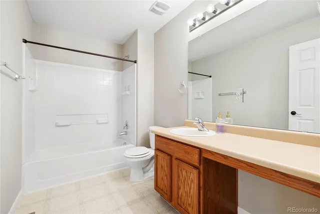 a bathroom with a sink a toilet a shower and a mirror