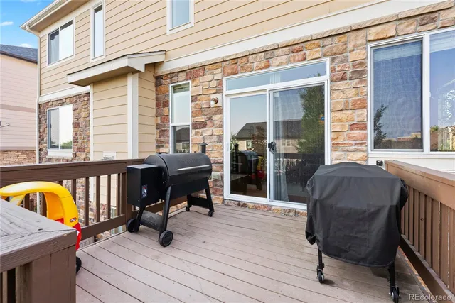 a view of balcony with two chairs and a barbeque