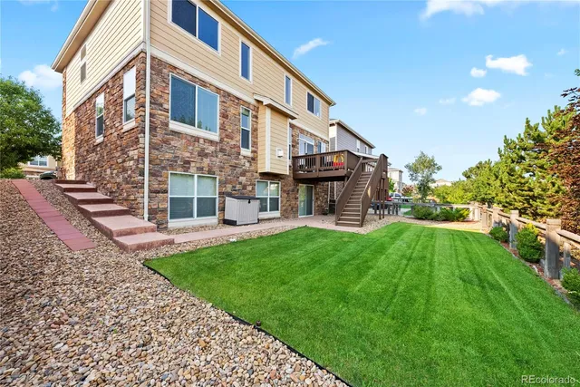 a view of house with a yard