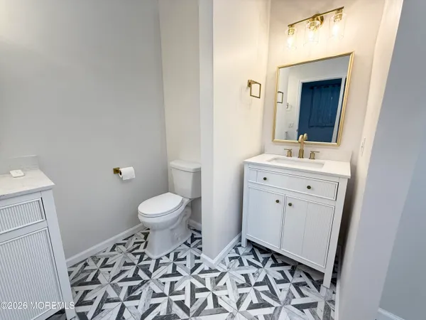 a bathroom with a sink a light fixture and a mirror