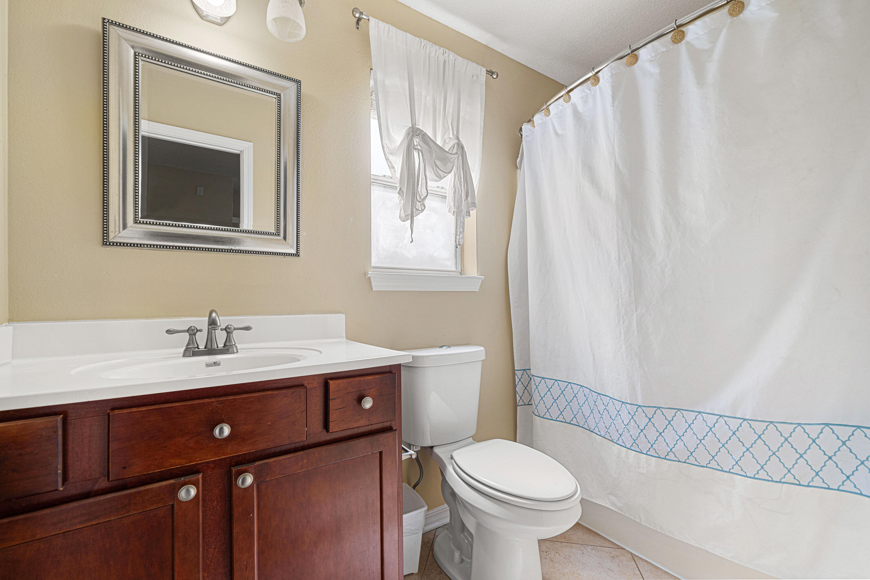 42 Vía Largo, Unit 7B Santa Rosa Beach, FL 32459 - Photo 11 of 36 a bathroom with a granite countertop sink mirror vanity and toilet