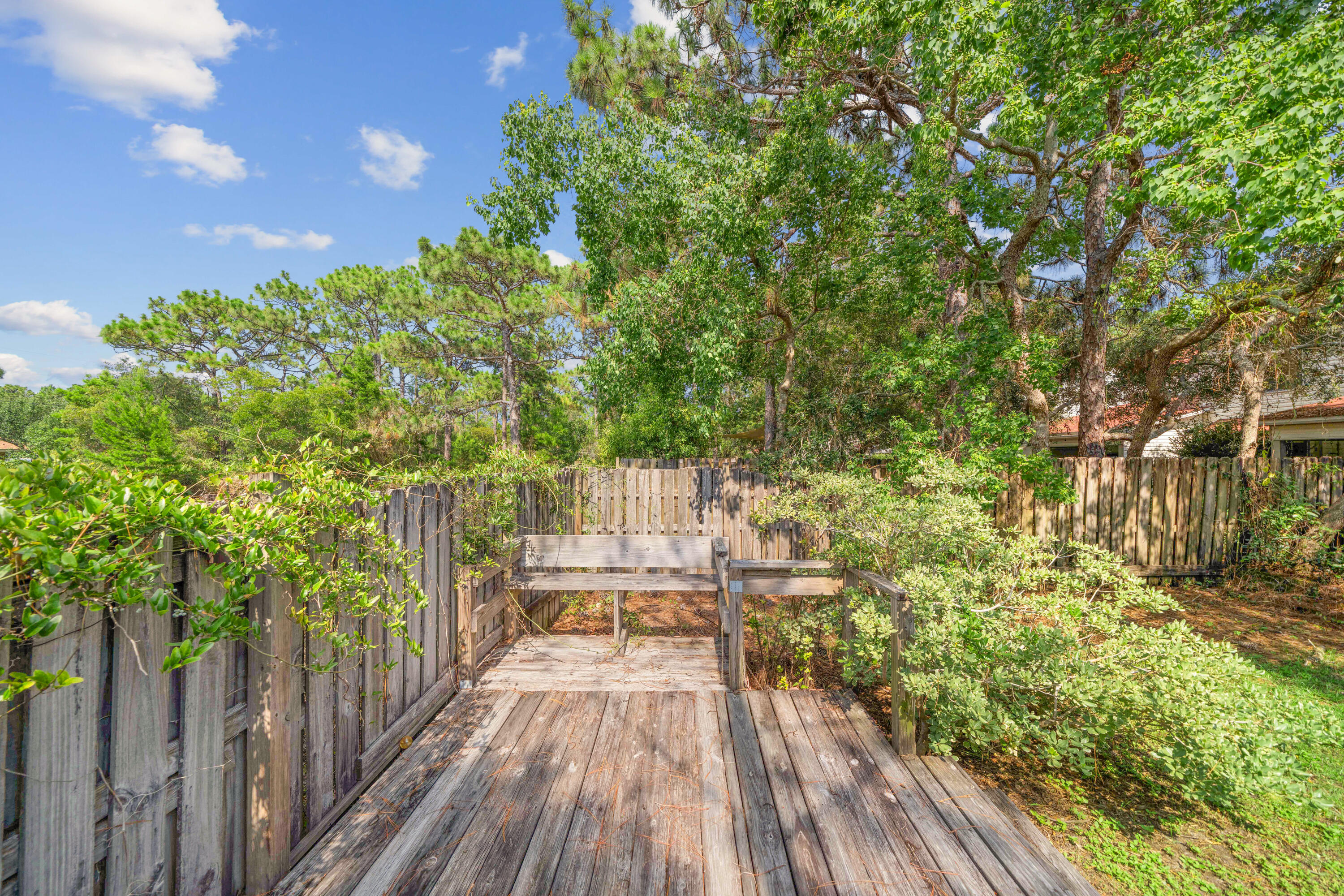 42 Vía Largo, Unit 7B Santa Rosa Beach, FL 32459 - Photo 16 of 36 a balcony with wooden floor and yard in the back