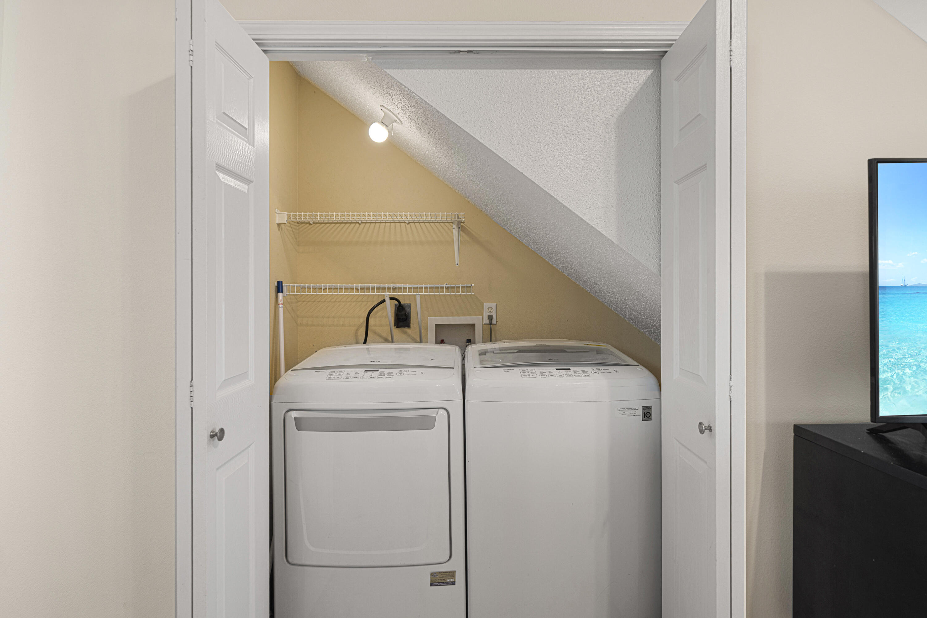 42 Vía Largo, Unit 7B Santa Rosa Beach, FL 32459 - Photo 19 of 36 a utility room with dryer and washer