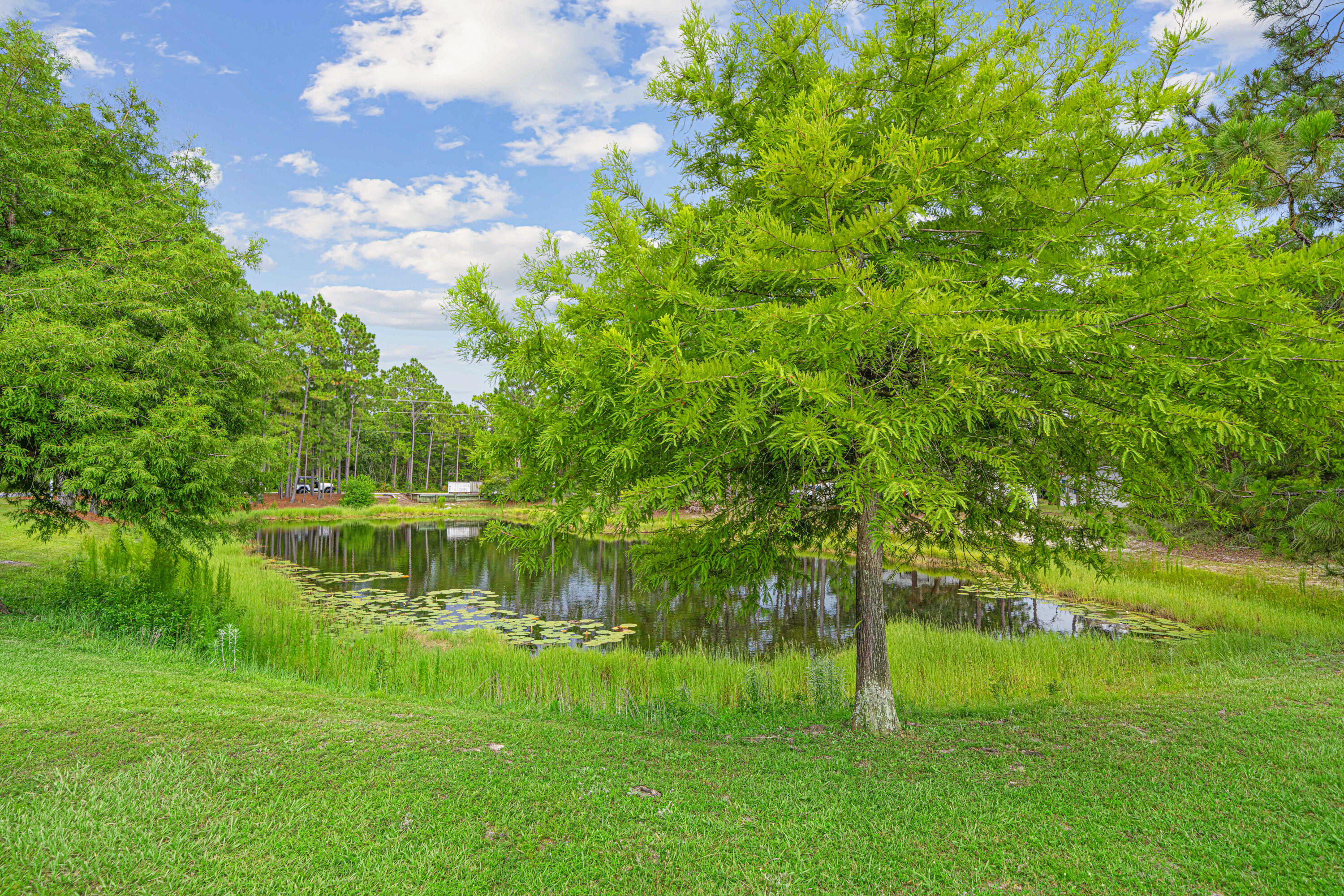 42 Vía Largo, Unit 7B Santa Rosa Beach, FL 32459 - Photo 24 of 36 a view of a lake with a yard
