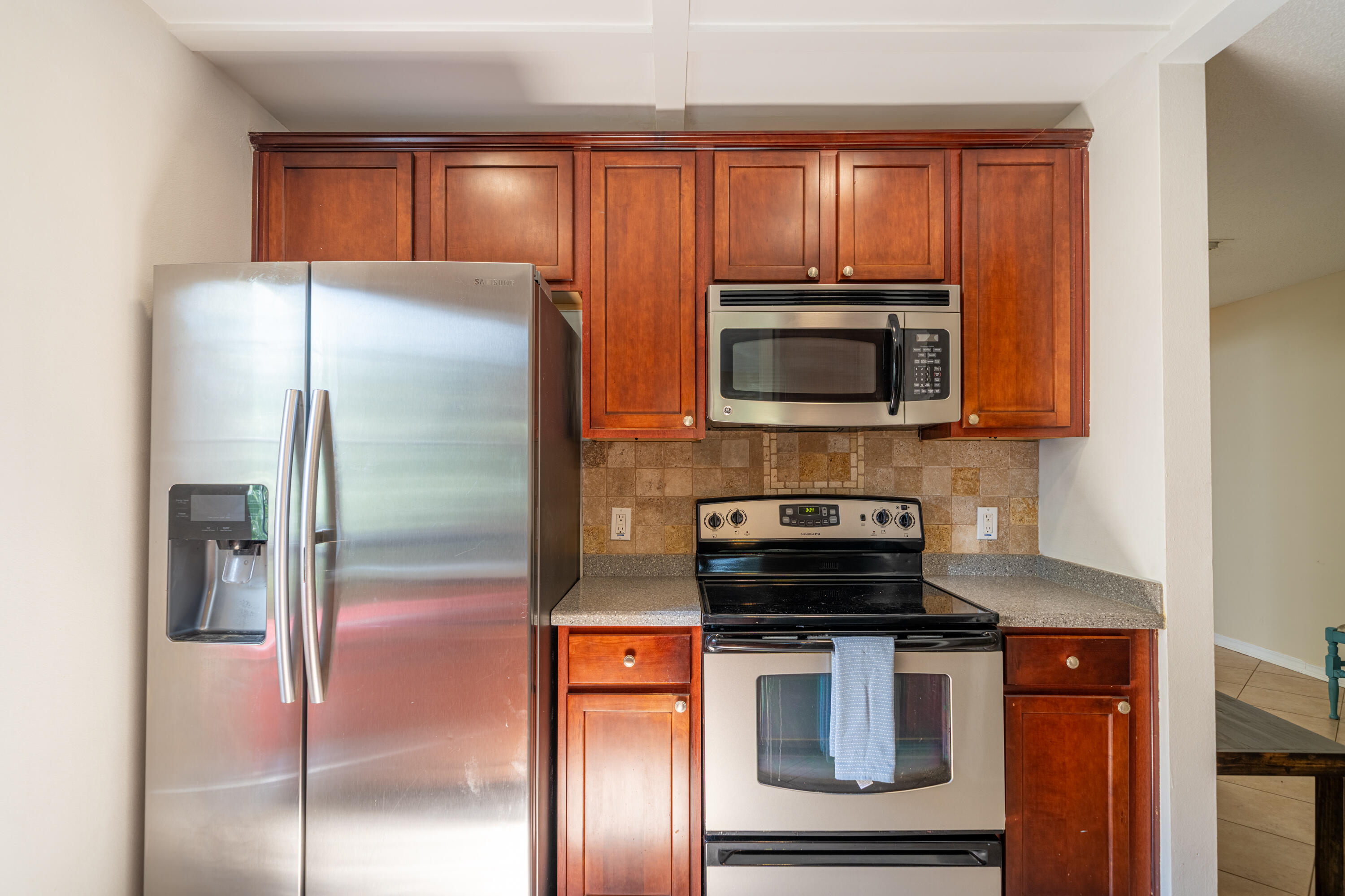 42 Vía Largo, Unit 7B Santa Rosa Beach, FL 32459 - Photo 6 of 36 a kitchen with a refrigerator stove and microwave