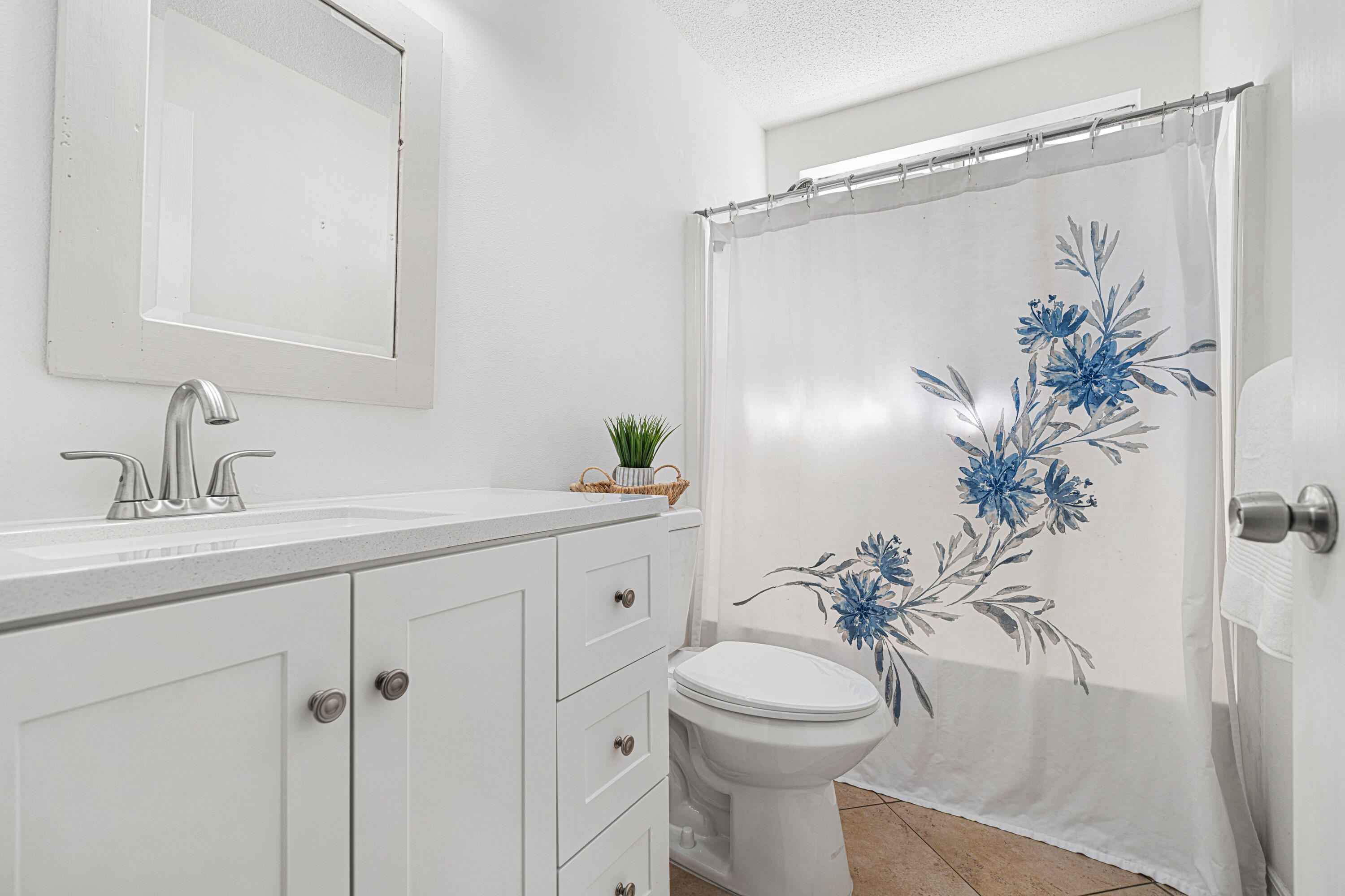 42 Vía Largo, Unit 7B Santa Rosa Beach, FL 32459 - Photo 8 of 36 a bathroom with a sink a toilet and a mirror