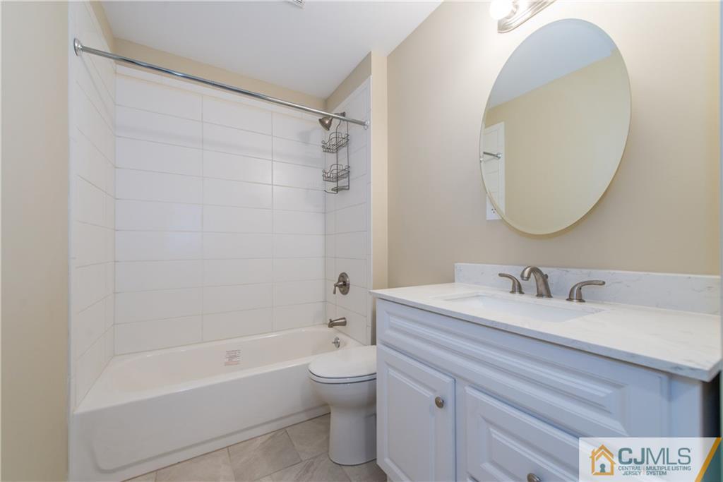 60 Morgan Drive Edison, NJ 08817 - Photo 13 of 20 a bathroom with a sink a toilet and a mirror