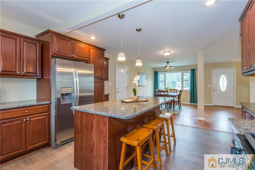 60 Morgan Drive Edison, NJ 08817 - Photo 8 of 20 a kitchen with stainless steel appliances granite countertop wooden cabinets a dining table and chairs