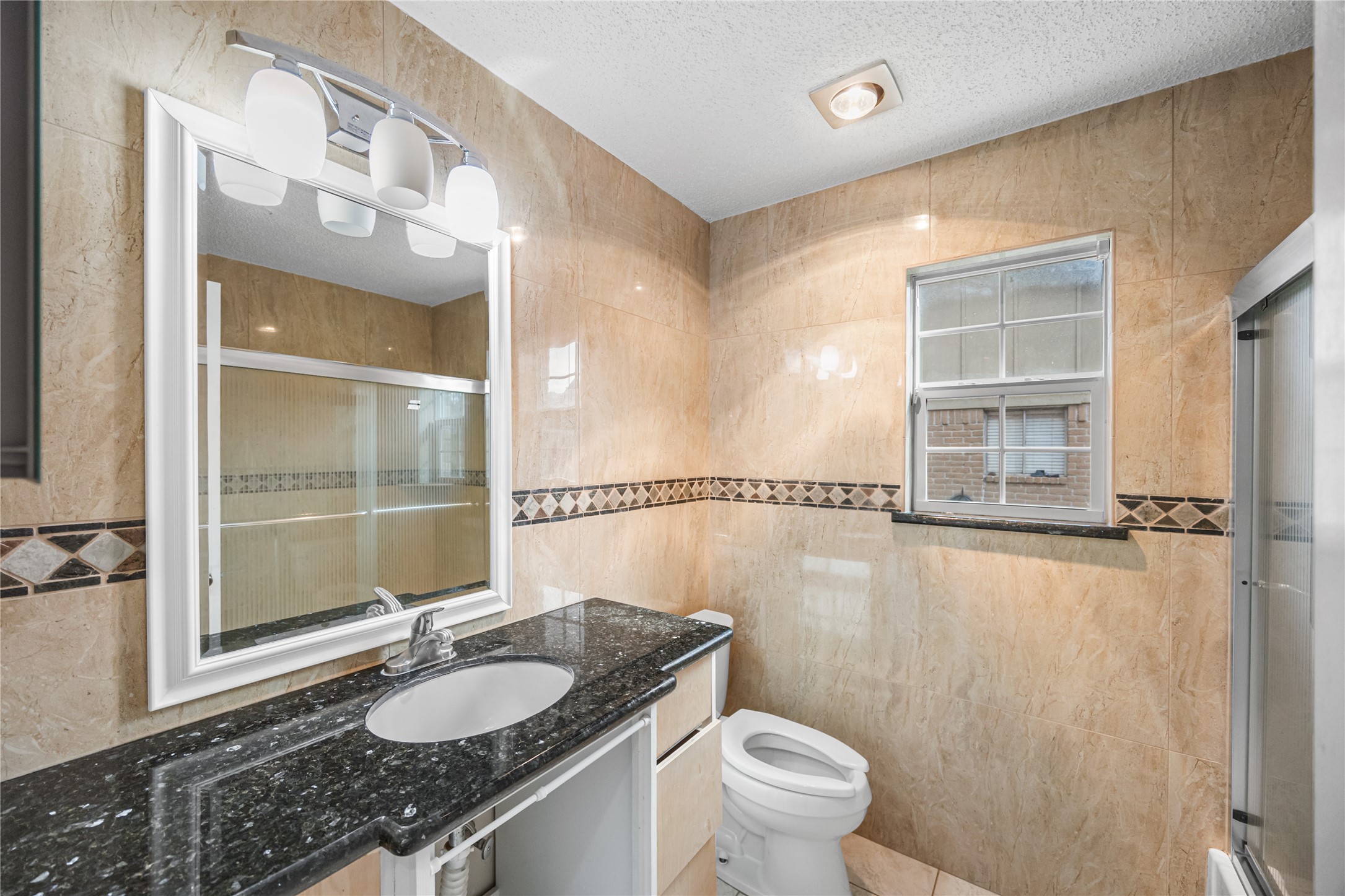 7211 Sandswept Lane Houston, TX 77086 - Photo 13 of 29 a bathroom with a granite countertop sink toilet and shower