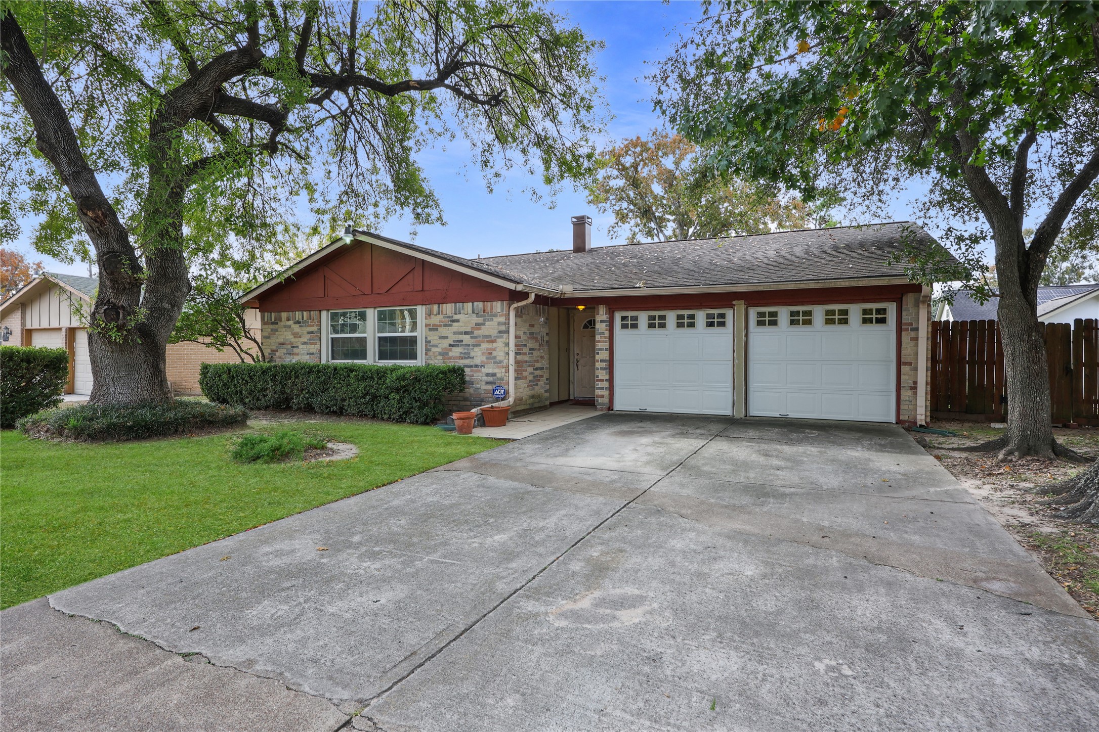 7211 Sandswept Lane Houston, TX 77086 - Photo 2 of 29 a front view of a house with a yard and garage