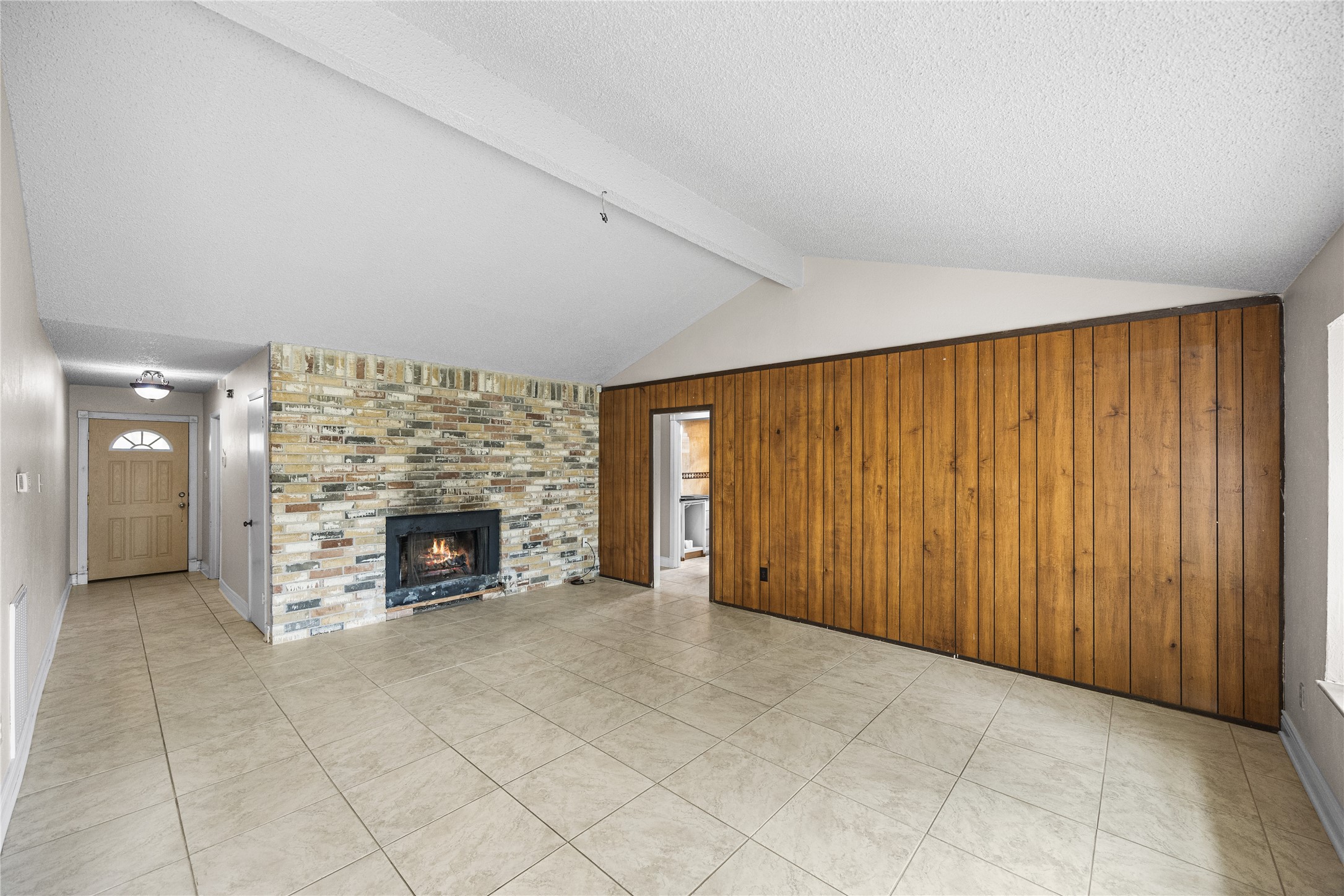 7211 Sandswept Lane Houston, TX 77086 - Photo 8 of 29 an empty room with furniture and a fireplace