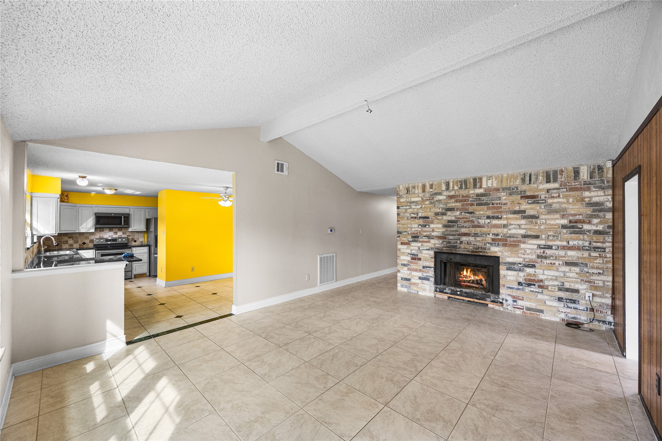 7211 Sandswept Lane Houston, TX 77086 - Photo 10 of 29 a view of a livingroom with a fireplace and a kitchen