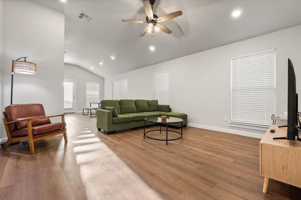 a living room with furniture and a flat screen tv