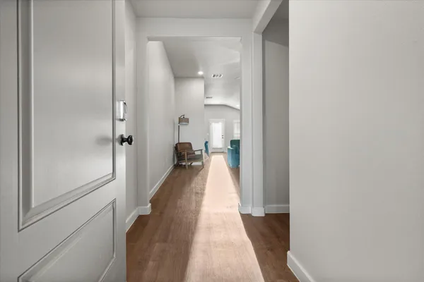 a view of a hallway with a wooden floor