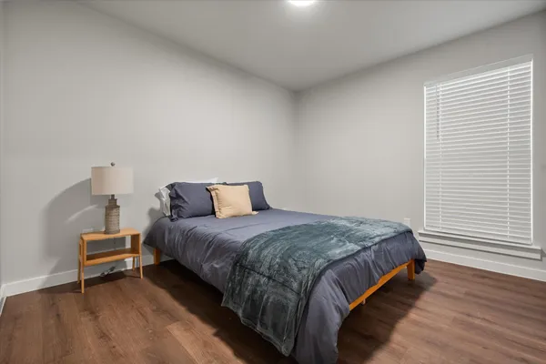 a bedroom with a bed and a night stand