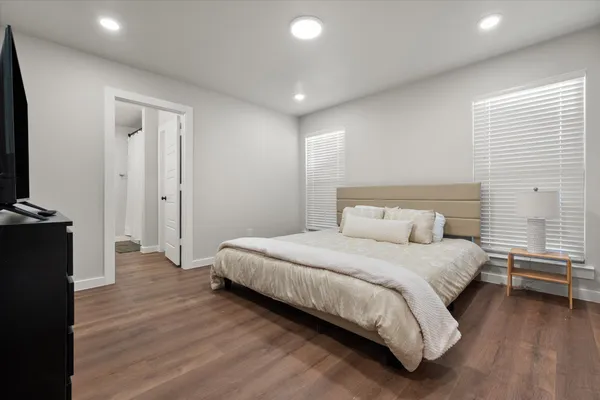 a bedroom with a bed and a television