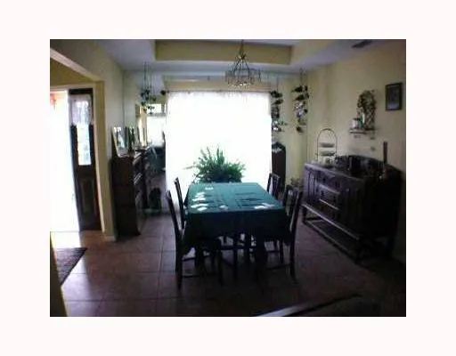 a living room with furniture and a dining table