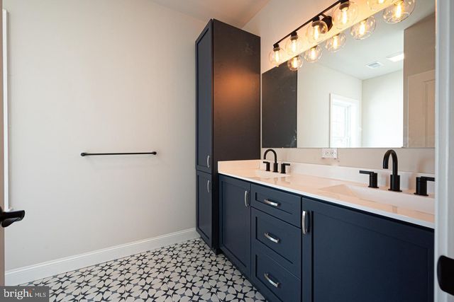 a bathroom with a double vanity sink and a mirror