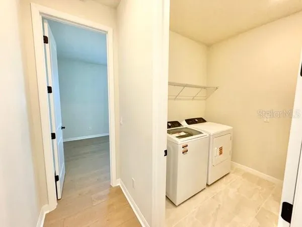 a view of a storage & utility room with a sink
