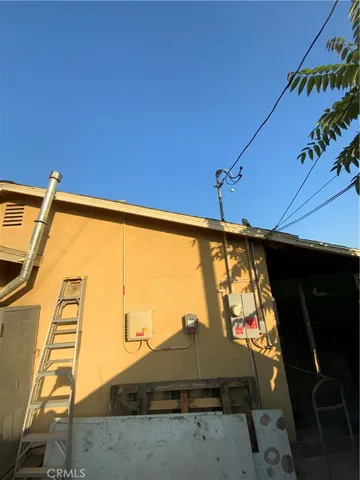 a blue chair sitting in front of a umbrella