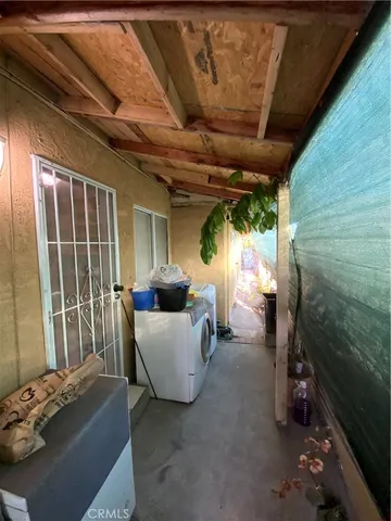 a living room with patio furniture and a floor to ceiling window