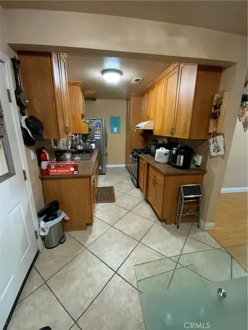 a kitchen with stainless steel appliances kitchen island granite countertop a stove a sink and a refrigerator